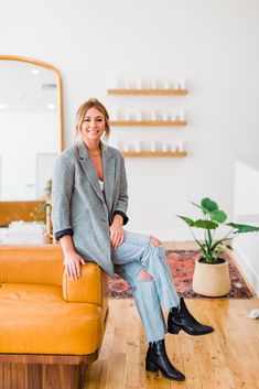 a woman sitting on top of a couch in a living room