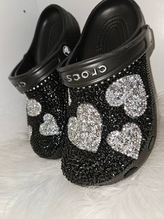 Women's size (black) clogs bling out with black diamonds with silver hearts You can request a different color clog by request. Can be substituted with gold hearts by request. Can be done with stars by request Bedazzled Crocs Winter's Lemonade Stand, Bedazzled Crocs Shoes Pink, Decorated Crocs, Customize Crocs, Blinged Out Crocs, Croc Ideas, Crocs With Charms, Bedazzled Shoes Diy, Bling Crocs