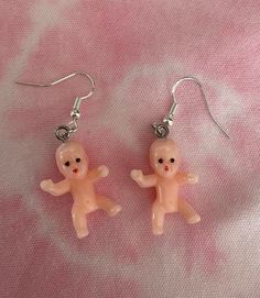 These baby dangle earrings never fail to get noticed! Each baby is approximately 2.5cm long. Each earring drop is made from 925 sterling silver, so lead and nickel free and safe to wear.  As this is a handmade product, slight colour and size variations may occur.  Rubber earring backs will be provided with each pair. Your earrings will be dispatched within 1-2 days and sent via Royal Mail 1st Class.  Due to hygiene reasons, returns will be accepted but only if the product is faulty. Please get in touch if you have any questions or particular requirements and I'll do my best to help. Any feedback is welcome to help grow my small business.  *New products added weekly, please follow the store and check back regularly to see our product line grow* Instagram @fill.ya.holes Doll Earrings, King Cake Baby, Weird Jewelry, Funny Earrings, Ugly Dolls, Baby Earrings, Fashion Christmas, Nickel Free Earrings, Statement Jewellery