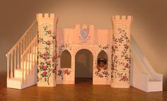 a miniature castle with stairs and flowers on it