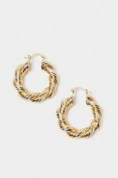 Loeffler Randall Atticus Large Twisted Hoops in gold-plated brass. 100% Gold-Plated Brass. Gold Metal Jewelry With Gold-tone Hardware, Gold Jewelry With Gold-tone Hardware In Brass, Gold-plated Hoop Jewelry With Gold-tone Hardware, Gold Plated Hoop Jewelry With Gold-tone Hardware, Gold Plated Hoop Earrings With Gold-tone Hardware, Atticus, Loeffler Randall, Hoop Earrings, Plating