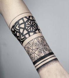 a person's arm with a tattoo on it and an intricate design in the middle