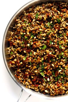 a pan filled with rice and vegetables on top of a table