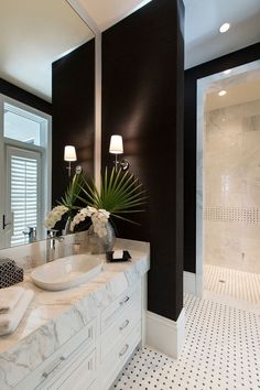 a bathroom with two sinks and a large mirror