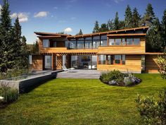 a large house with lots of windows in the front yard