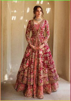 Royal Pishwas Frock Lehenga Pakistani Bridal Dress is a magnificent masterpiece that gives the gorgeous bride her desired dreamy appearance at the wedding. Resham, dabka, gota, Kiran, and sequins make this Pishwas Dress your priority for the big day. Pishwas: The Pishwas Frock has the perfect contrast of glamorous red and pink colors. The Pishwas come in layered style and is hand-embellished with fine details of Resham, sequins, cut-dana, Kiran, Gota, and Naqshi work. Intricate designs and beaming ornaments make this Pishwas Dress an epitome of royalty. Lehenga: The Traditional Pishwas is paired with Lehenga to create a chic Pakistani Bridal Dress. The Lehenga has a mesmerizing pink color and is also adorned with pearls, resham, and tilla work, making it a perfect choice for the wedding. D Anarkali For Bride, Red Bridal Anarkali Suits, Anarkali Dress For Engagement, Anarkali Suits For Engagement, Anarkali Bridal Dress, Desi Bridal Outfits, Wedding Anarkali Dress Indian Bridal, Anarkali Bridal Suits, Frocksuit Design For Women