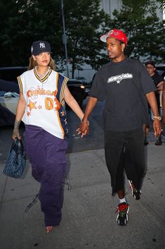 a man and woman walking down the street