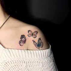 a woman's shoulder with three butterflies on it