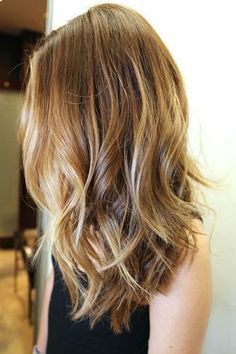 the back of a woman's head with wavy hair