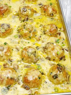 a casserole dish filled with meatballs and cheese