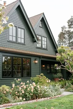 a green house with lots of windows and flowers