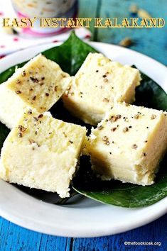 four pieces of cake on a plate with leaves and spices in the background that says easy instant kalakaland