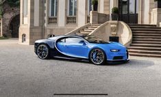 a blue bugatti parked in front of a large building with steps leading up to it