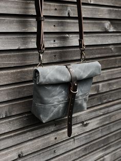 This day bag / satchel is your perfect companion for the days when you only need some necessities to take with you. The day bag is made in heavy weight waxed filter twill in the color grey , with roll to close top, with snap and strap closing. Made it with a double layered bottom, for extra durability and strength. Phone pocket on the backside closing with pouch button. With adjustable and detachable shoulder strap in vegetable tanned leather Fully lined with a cotton canvas The size of this bag Canvas Bags With Gunmetal Hardware For Everyday Use, Practical Waxed Canvas Satchel Shoulder Bag, Waxed Canvas Satchel For Everyday Carry, Canvas Shoulder Bag With Gunmetal Hardware For Travel, Canvas Bags With Adjustable Strap For Everyday, Travel Shoulder Bag With Gunmetal Hardware In Canvas, Practical Canvas Bags For Everyday Carry, Practical Canvas Bag For Everyday Carry, Everyday Canvas Tote Shoulder Bag