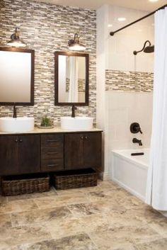 a bathroom with two sinks and a tub