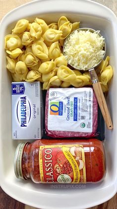 pasta, cheese and sauce in a white container