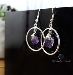 These gorgeous silver plated earrings have a deep purple amethyst in the center of the circle. Amethyst will bring you enhanced intuition and spiritual growth, while the circle is the universal symbol of wholeness, the self and the infinite Size 1" diameter and 0.5 Amethyst Due to the nature of real crystals/gem stones the pieces will have natural variations in color, details, and overall appearance. Ships within 2 Business Days Real Crystals, Amethyst Point, Gem Stones, The Circle, Crystal Gems, Spiritual Growth, Purple Amethyst, Deep Purple, Silver Plated