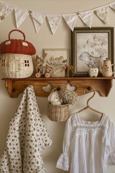 a shelf filled with baskets and other items on top of a wooden shelf next to a white wall