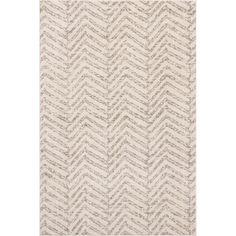 a white rug with grey and beige chevrons on the bottom, in front of a