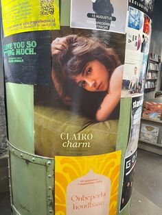 there is a poster on the side of a pole that has been decorated with magazines