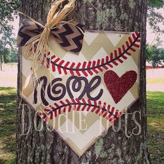 a baseball themed door hanger on a tree