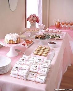 a table topped with lots of cakes and desserts