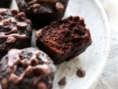 chocolate muffins on a plate with one cut in half