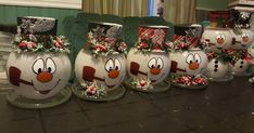 several snowman vases are sitting on a table