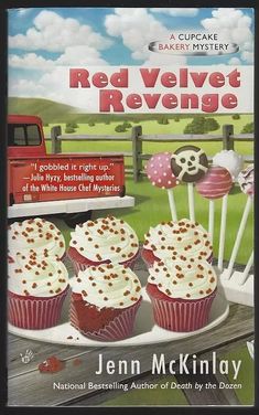 a book cover with cupcakes on a plate