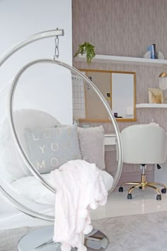 a bedroom with a hanging chair and desk