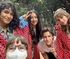 four women wearing face masks posing for a photo