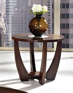 a vase with flowers sitting on top of a wooden table in front of a window