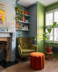 a living room filled with furniture and a fire place in front of a painting on the wall