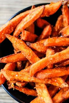 a black bowl filled with sweet potato fries