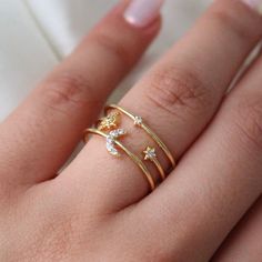 "Star & Moon Ring, Gold Stackable Star Ring, CZ Rings, Star Dangle Ring, Dainty Stackable Rings, Moon and Star Ring, Gold Moon Jewelry, Star Ring Star and Moon Ring, Adjustable Star Rings, Water Resistant Ring Unique Christmas Gifts, Gift for girlfriend. Christmas Gift, Christmas gift for her, Gift for mother. . . . * Width: 7mm * 18 Karat Gold Plated * Electrophoresis Plating For Tarnish Resistance * Packaged With Free Gift Box * A perfect gift for her. . . . If you have any questions, just hit the \"Message the Seller\" button ( bottom right of the page) and we will get back to you within a few hours. . . . Mailed in a cute white package great for gifting. . . . High-Quality Solid 14k Yellow Gold . . . Check our Social Media @TalaJewels, and let's be friends! . . . Made in the USA . . . Adjustable Celestial Star-shaped Rings, Celestial Star-shaped Stackable Promise Rings, Rings Moon, Rings Star, Star Rings, Dangle Ring, Cz Rings, Jewelry Star, Girlfriend Christmas