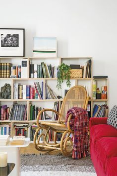 a living room filled with lots of books and furniture