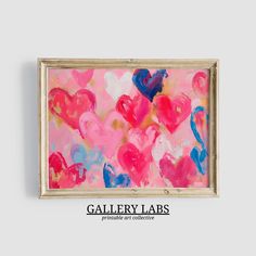 a painting with hearts painted on it in pink, blue and red colors is hanging up against a white wall