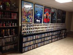 there are many movies on the shelves in this room