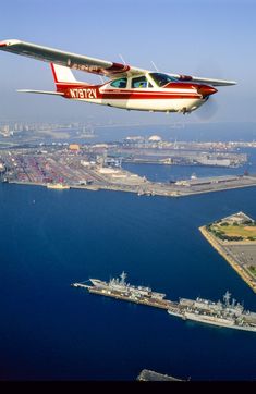 an airplane is flying over the water and land