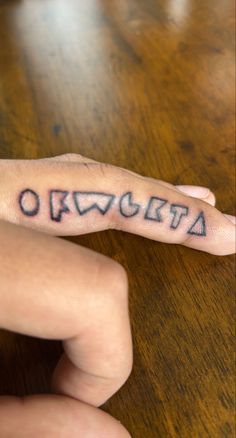 a person's hand with a tattoo on it and the word origa written in cursive writing