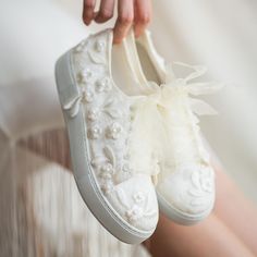 a close up of a person's white shoes