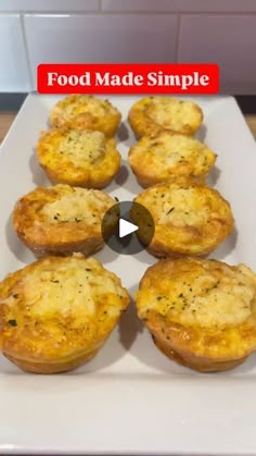 a white plate topped with mini quiches on top of a wooden table next to a red sign that says food made simple