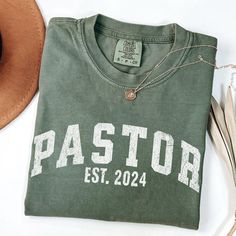 Looking for a unique and stylish way to show your love and appreciation for your pastor? Look no further than this retro-style Pastor t-shirt!. Crafted from high-quality materials, this t-shirt is not only comfortable to wear but also durable, making it a perfect gift for your beloved pastor. The retro-style design is eye-catching and classic, featuring the words "Pastor Established" in bold, vibrant colors. Not only is this t-shirt a great addition to your wardrobe, but it also makes a thoughtful and meaningful gift for any occasion. Whether you're celebrating a special anniversary or just want to show your love and appreciation, this t-shirt is sure to make your wife feel loved and valued. Available in a range of sizes and colors, you're sure to find the perfect retro-style Pastor's wife Youth Pastor Gifts, Pastor Shirt, Pastor Anniversary, Pastor's Wife, Pastors Wife, Gifts For Pastors, Feel Loved, Christian Tees, Comfort Colors Tee