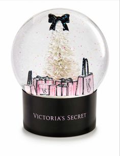 the victoria's secret snow globe is shown in front of a white christmas tree