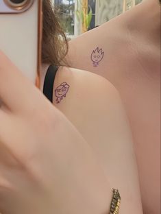 two women with matching tattoos on their backs