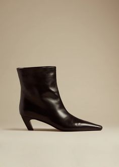 The Arizona Boot in Black Leather – KHAITE Classic Square Toe Boots With Branded Heel, Sleek Square Toe Calf Leather Boots, Sleek Leather Square Toe Boots, Sleek Calf Leather Boots With Square Toe, Sleek Square Toe Boots With Branded Heel, Sleek Boots With Branded Heel Counter And Square Toe, Classic Square Toe Boots With Heel Pull Tab, Classic Boots With Square Toe And Heel Pull Tab, Everyday Boots