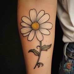 a daisy tattoo on the arm