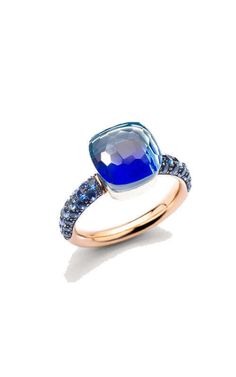 a blue and white ring with diamonds on the sides, set in yellow gold plated silver