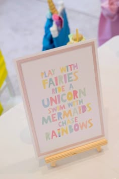 there is a sign that says play with fairies like unicorns and mermaids rainbows