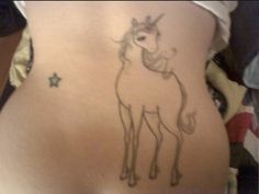 a drawing of a unicorn on the back of a woman's stomach is shown